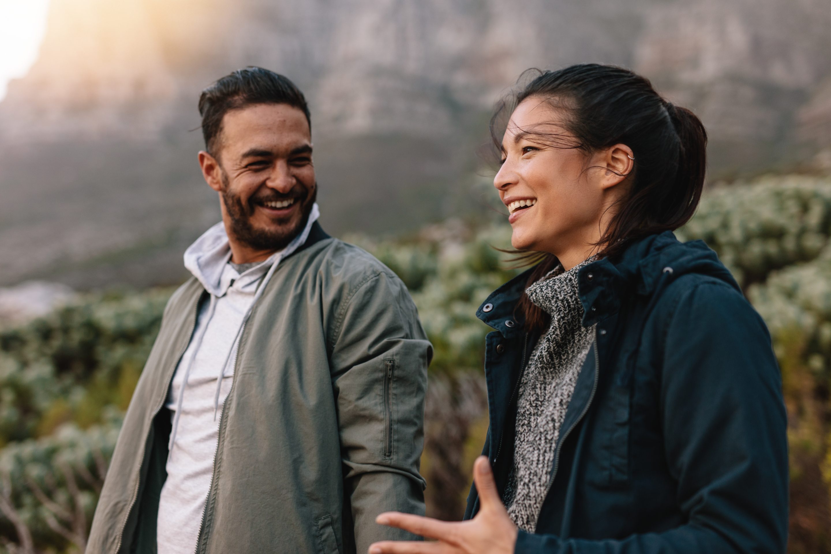 Couple outdoors with great smiles talking